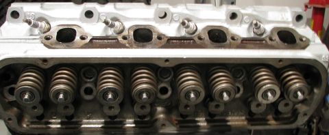 1980 Ford Bronco - This is a close-up view of an engine's cylinder head, showing the spark plug holes and valve train components.