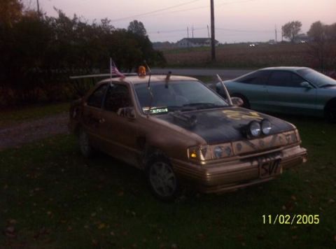 1993 Mercury Topaz - A modified 1993 Mercury Topaz sits in a grassy yard with another car in the background.