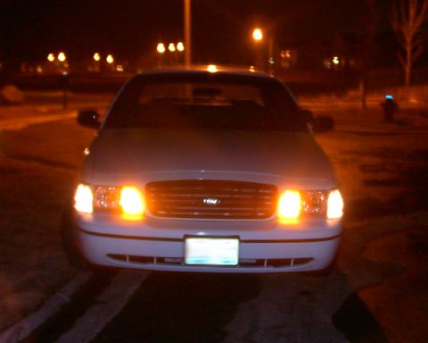 1999 Ford Crown Victoria - This 1998 Ford Crown Victoria is shown from the front at night, with its headlights and turn signals illuminated.
