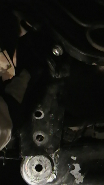 1995 Ford Bronco - Close-up view of an axle pivot bracket, showing its mounting points and hardware.