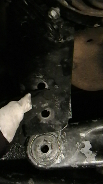 1995 Ford Bronco - A close-up view of a vehicle's suspension component, possibly an axle pivot bracket.