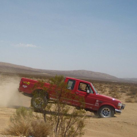 1996 Ford Bronco - This red 1996 Ford F-150 pickup truck kicks up dust as it navigates a desert landscape.