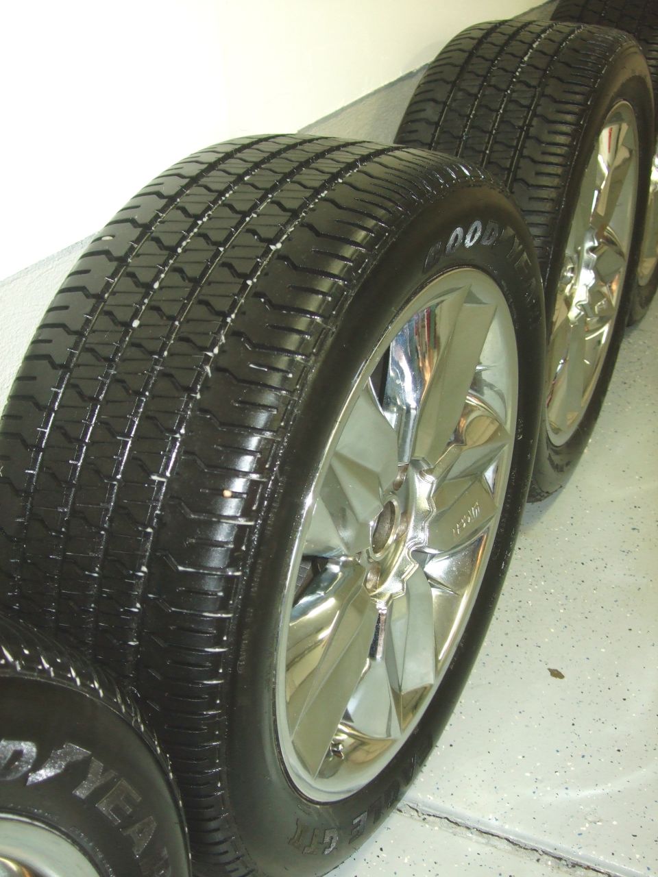 Four chrome wheels with Goodyear tires lined up