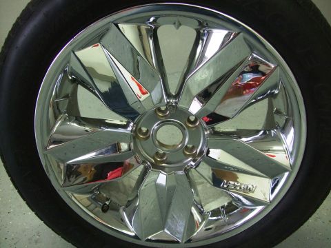 1987 Ford Bronco - A close-up of a chrome wheel with a "LEXANI" logo, mounted on a black tire.