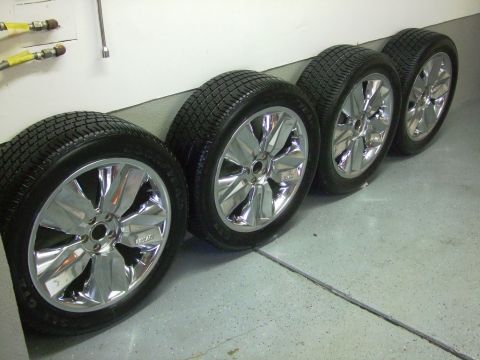 1987 Ford Bronco - Set of four chrome wheels and tires stored indoors.