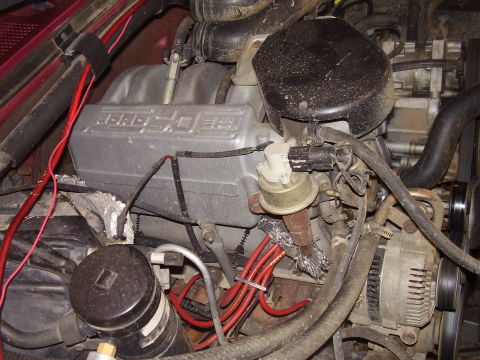 1994 Ford Bronco - Close-up view of an engine bay, highlighting the intake manifold, distributor, and associated wiring.