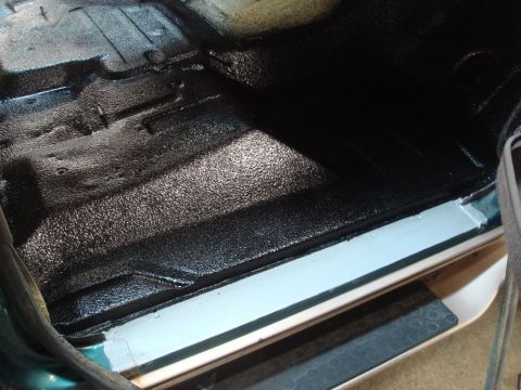 1996 Ford Bronco - Vehicle interior floor treated with a protective spray coating.