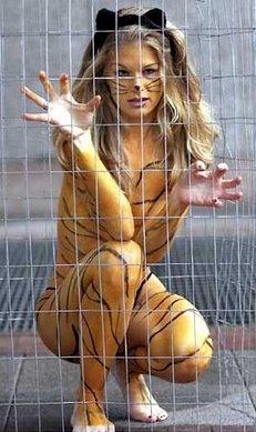 2000 Ford Crown Victoria - A woman dressed as a tiger is seen behind a wire fence.