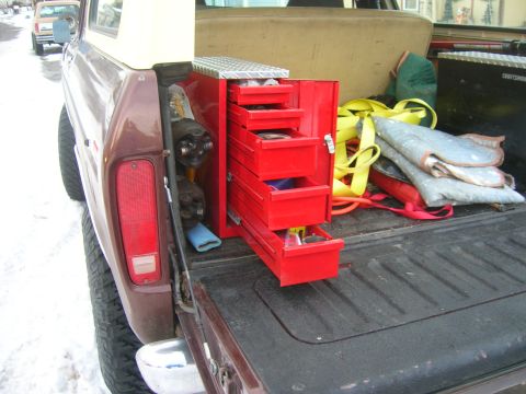 1979 Ford Bronco - View of the bed of a 1979 Ford Bronco, showing a red toolbox and various straps.
