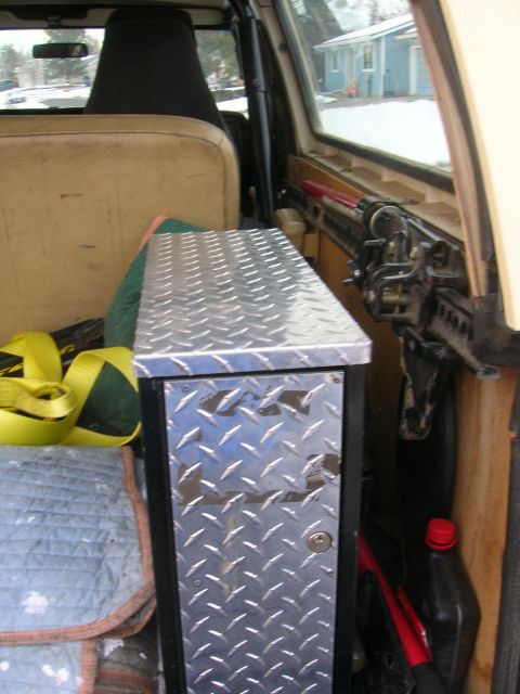 1979 Ford Bronco - Interior view of a vehicle, showing a diamond plate storage box and seating area.