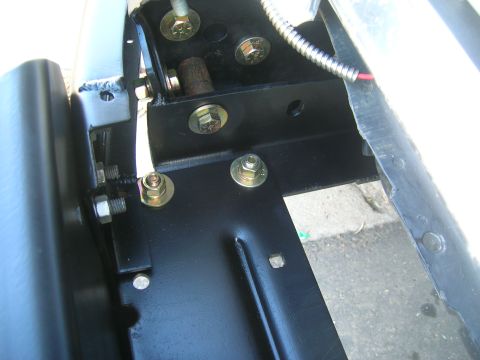 1979 Ford Bronco - Close-up view of the mounting hardware for a winch bumper, showing bolts and brackets.