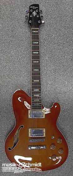 1995 Ford Bronco - A sunburst hollow-body electric guitar rests on a textured surface, displaying its pickups and controls.