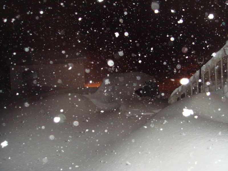 Vehicle buried in snow during a blizzard