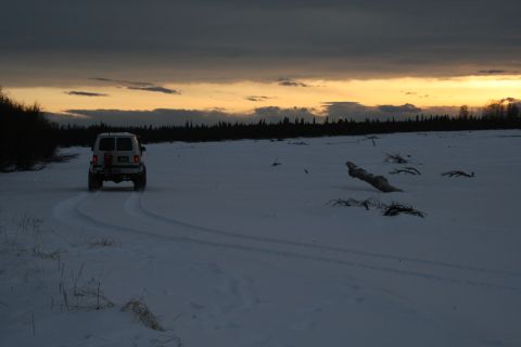 2003 Jeep TJ - A white Jeep TJ navigates a snowy landscape during a dramatic sunset.