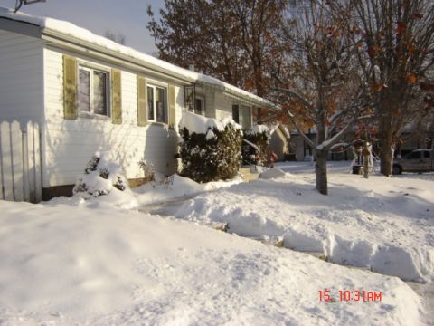 1990 Ford Bronco - A winter scene shows a house and yard covered in snow.