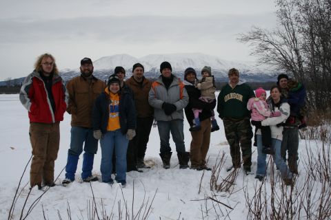 2003 Jeep TJ - A group of people pose for a photo in a snowy outdoor setting with mountains visible.