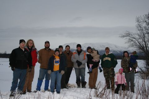 2003 Jeep TJ - A group of people pose for a photo in a snowy landscape with mountains visible in the distance.
