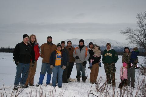 2003 Jeep TJ - A group of people pose for a photo in a snowy, outdoor setting with mountains visible on the horizon.