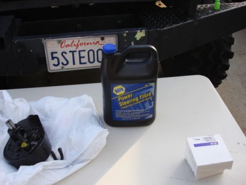 1983 Ford Bronco - while here i wanted to flush the system so i got 1 gallon of NAPA fluid.you can see the new reman pump to the left.