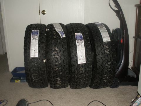 1986 Ford Bronco - Four new BFGoodrich All-Terrain T/A KO2 tires are lined up indoors.