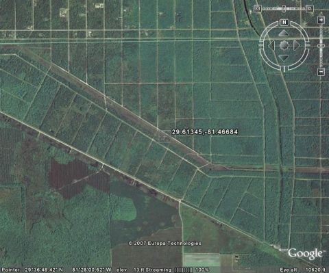 1989 Ford Bronco - An aerial perspective captures a vast expanse of cultivated land divided by roads, forming a distinct grid.