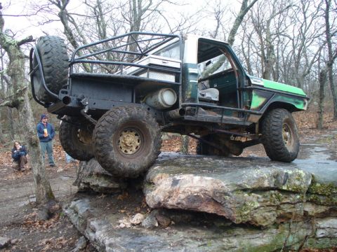 1978 Ford Bronco - This heavily modified truck navigates a rocky trail, its off-road capabilities.
