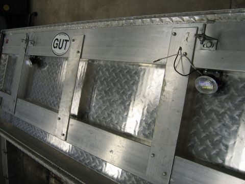 2001 Ford F-150 - Close-up of an aluminum truck bed section, diamond plate panels and exterior lighting.