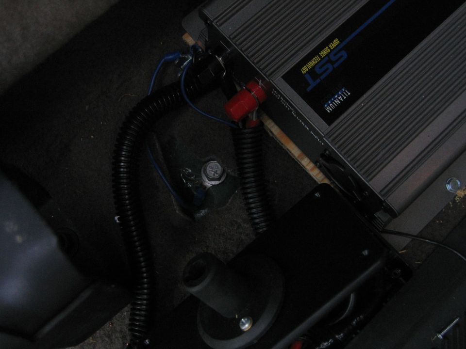 SST Titanium amplifier on floor board with loom-wrapped power leads and floor ground