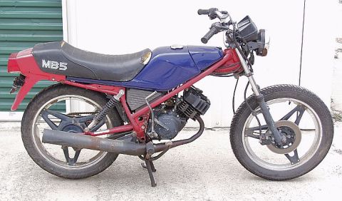 1985 Ford Crown Victoria LTD - This motorcycle has a red frame, blue fuel tank, and red tail section with 'MB5' visible on the side.