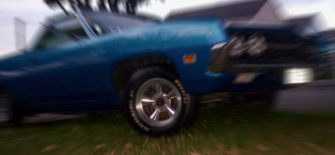 1970 Ford Ranchero - Side view of a blue 1970 Ford Ranchero with chrome trim and aftermarket wheels.