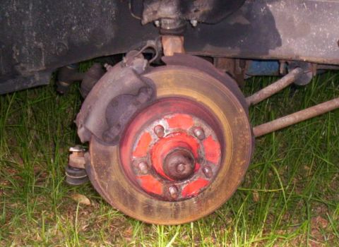 1970 Ford Ranchero - Close-up of a vehicle's front disc brake assembly, showing the rotor and caliper.