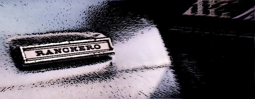 Ranchero badge on a light-colored surface, with a dark area to the right