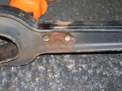 1979 Ford Bronco - A close-up view of a rusty suspension component, likely from a vehicle's front end.