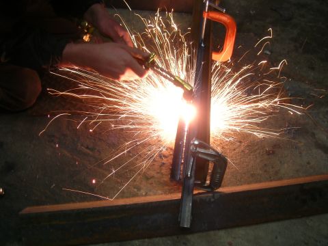 1979 Ford Bronco - A person is welding metal, creating a bright shower of sparks.