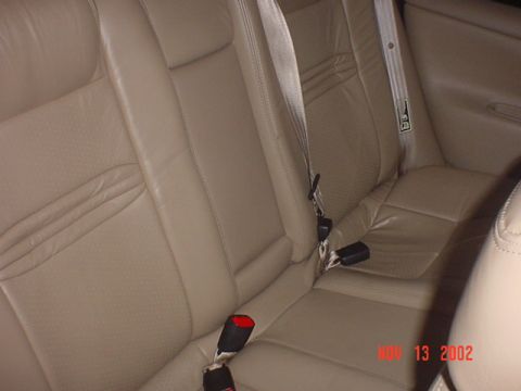 2000 Ford Contour - Interior view of tan leather rear seats and seatbelts. A date watermark indicates June 13, 2002.