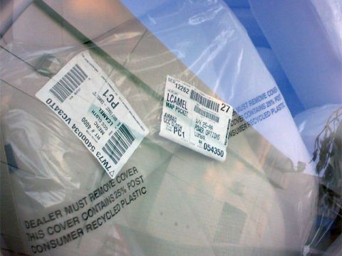 1999 Mercury Grand Marquis - Car interior parts, including seat covers and map pockets, are shown in protective plastic packaging with identification labels.