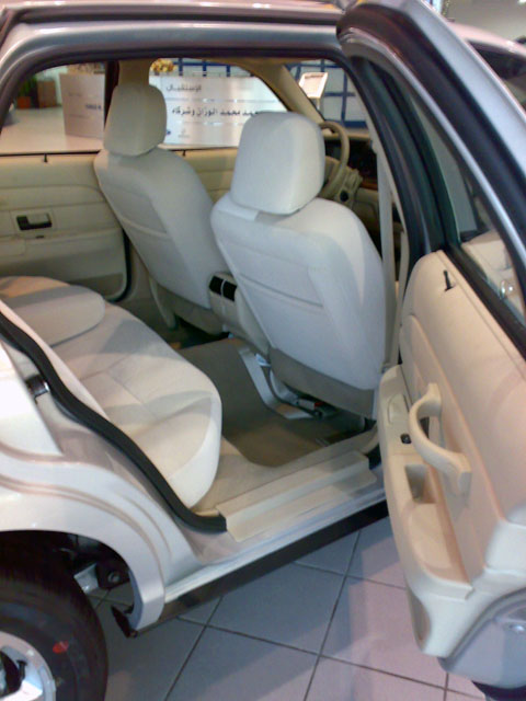 1999 Mercury Grand Marquis - The interior of a sedan, likely from the early 2000s, is viewed from the rear passenger side.