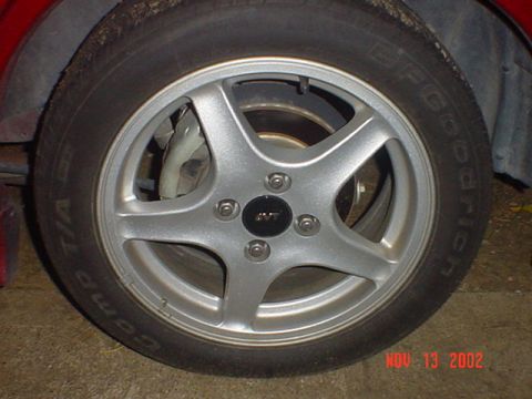 2000 Ford Contour - Close-up of a car's wheel and tire, with visible text on the tire sidewall and a watermark at the bottom.