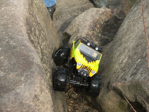 1996 Ford Bronco - A remote control rock crawler toy is shown navigating a rocky terrain.