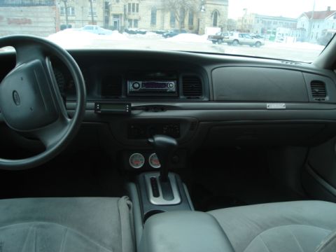 2000 Ford Crown Victoria - Interior view of a 2000 Ford Crown Victoria, showing the dashboard, steering wheel, and center console.
