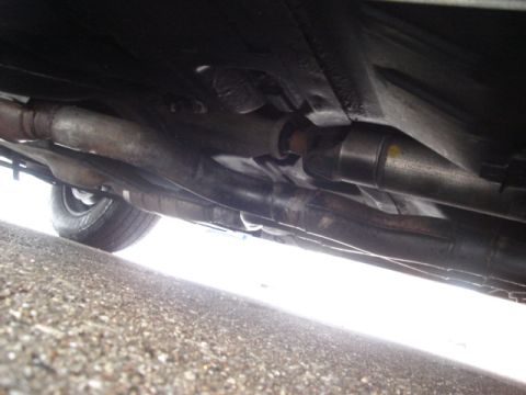 2000 Ford Crown Victoria - Underside view of a vehicle's exhaust system and driveshaft, showing various pipes and components.