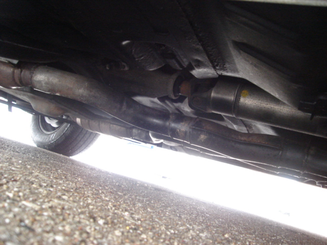 Underside view of vehicle exhaust and driveshaft