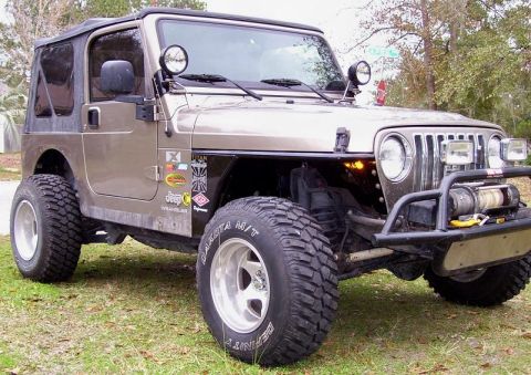 2004 Jeep TJ - This Jeep Wrangler features large off-road tires and a custom front bumper with a winch.