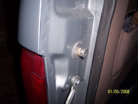 1996 Ford Bronco - Close-up of a vehicle's tailgate latch mechanism, with a date stamp visible in the corner.