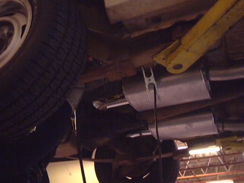 1969 Chevrolet Nova - Underside view of a vehicle's exhaust system and tire, with Supermotors.net logo.