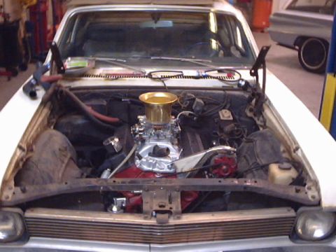 1969 Chevrolet Nova - The engine bay of a 1969 Chevrolet Nova is open, revealing its upgraded engine components.