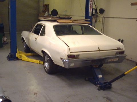 1969 Chevrolet Nova - This 1969 Chevrolet Nova coupe is shown from the rear while elevated on a car lift in a garage.