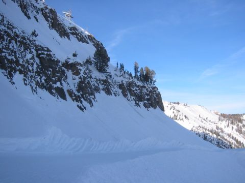 2006 BMW 5 Series - A vast, snow-covered mountain range under a bright blue sky, with a ski lift visible on the peak.