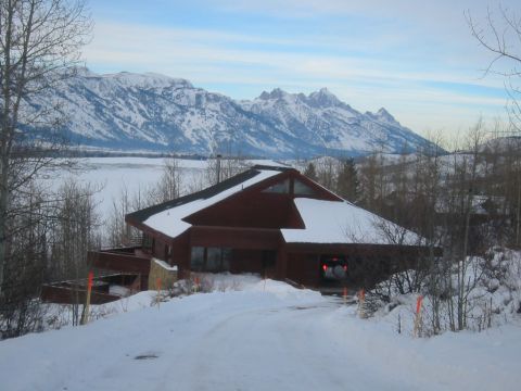 2006 BMW 5 Series - A winter scene with a house and mountains in the background.