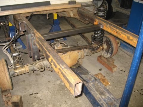 1990 Ford F-250 - Custom metalwork is being added to the frame and suspension of a truck, likely for a build or modification.